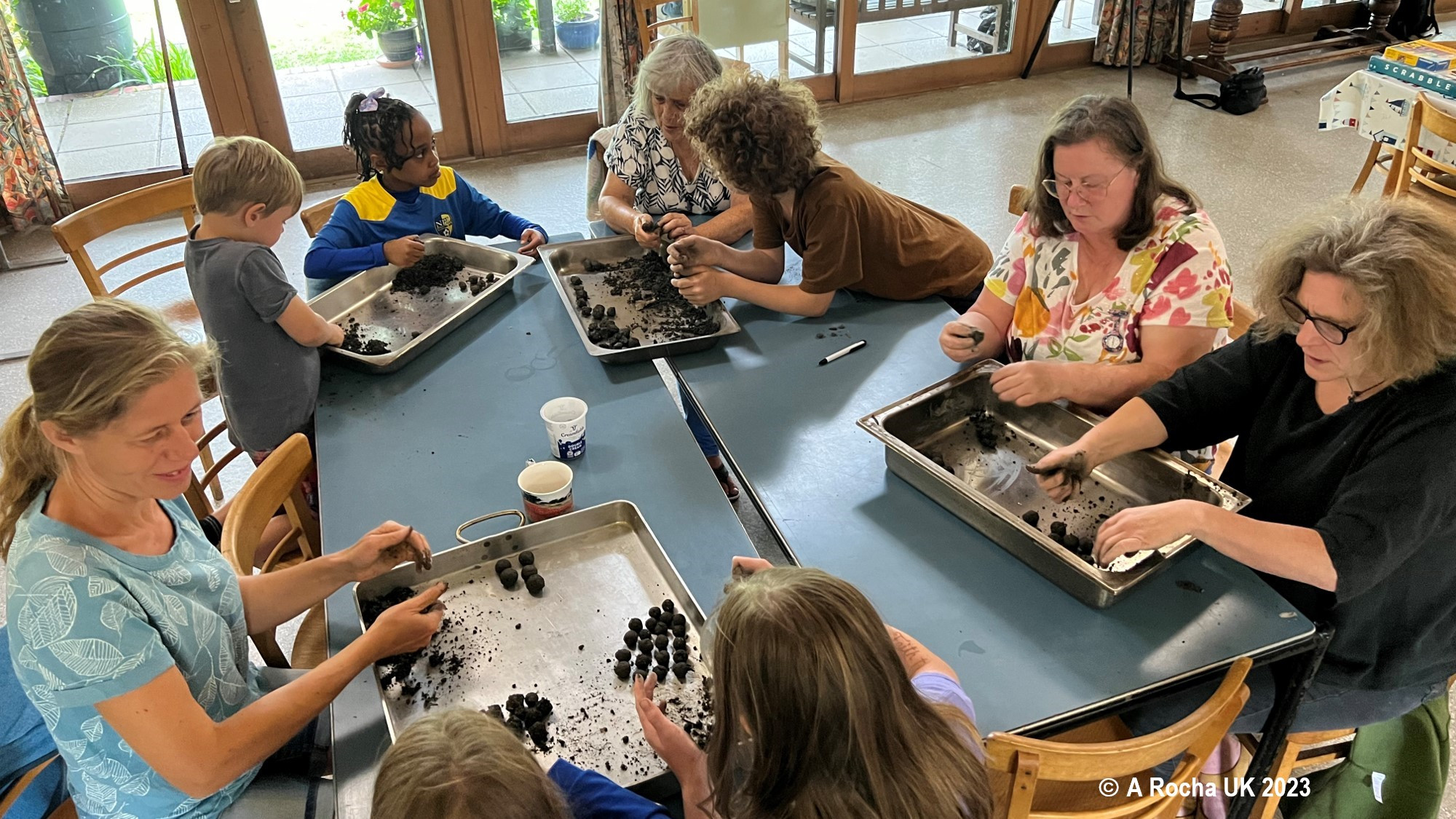 Group of adults and kids making wildflower seed bombs